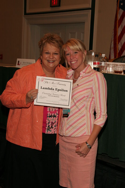 Kathy Williams and Lambda Epsilon Chapter Member With Certificate at Friday Convention Session Photograph 1, July 14, 2006 (Image)