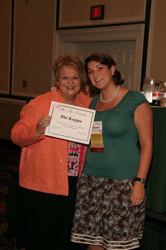July 14 Kathy Williams and Phi Kappa Chapter Member With Certificate at Friday Convention Session Photograph Image