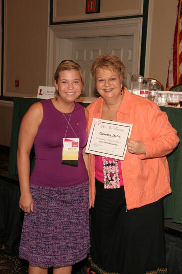 Kathy Williams and Gamma Delta Chapter Member With Certificate at Friday Convention Session Photograph 1, July 14, 2006 (image)