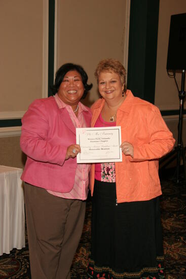 Kathy Williams and Winter Park Alumnae Chapter Member With Certificate at Friday Convention Session Photograph, July 14, 2006 (image)