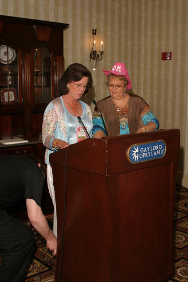 Shellye McCarty and Kathy Williams at Podium During Convention Officer Luncheon Photograph, July 2006 (image)