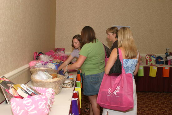 Phi Mus Looking at Gift Baskets at Convention Photograph, July 2006 (image)