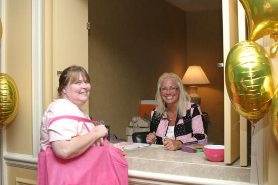 Two Unidentified Phi Mus at Convention Hotel Counter Photograph, July 2006 (image)