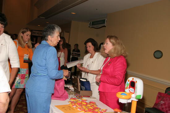 Sackinger, Lowden, and Ganim at Sale Table During Convention Photograph, July 2006 (image)