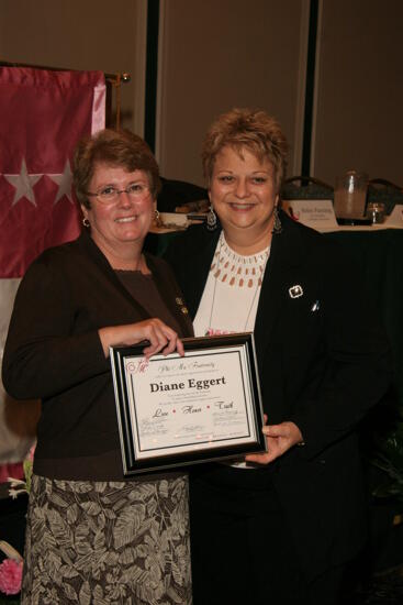 Kathy Williams and Diane Eggert With Plaque at Convention Sisterhood Luncheon Photograph 2, July 15, 2006 (image)