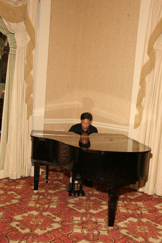 Victor Carreon Playing Piano at Convention Photograph 1, July 13, 2006 (Image)