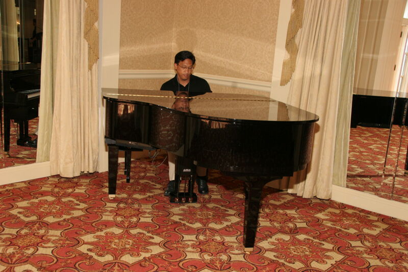 Victor Carreon Playing Piano at Convention Photograph 5, July 13, 2006 (Image)