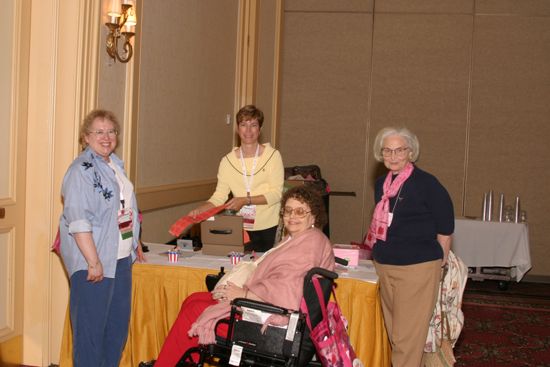 Four Phi Mus Setting Up Table at Convention Photograph, July 8, 2004 (image)