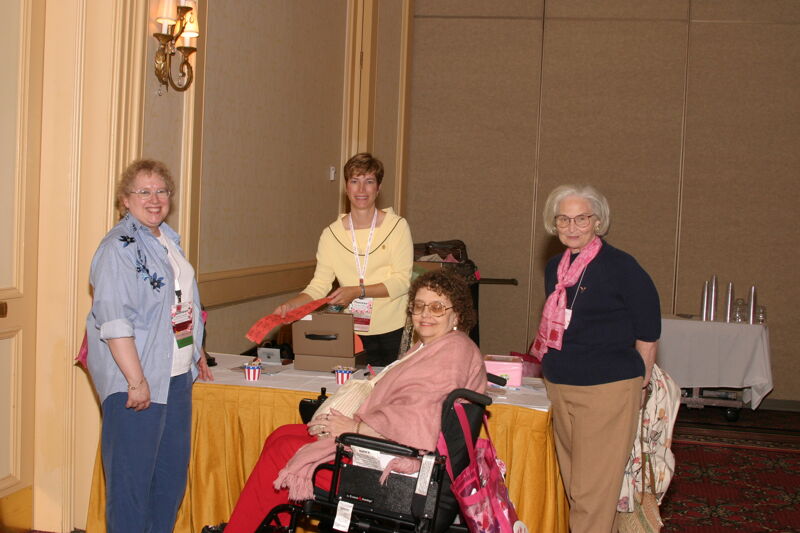 Four Phi Mus Setting Up Table at Convention Photograph, July 8, 2004 (Image)
