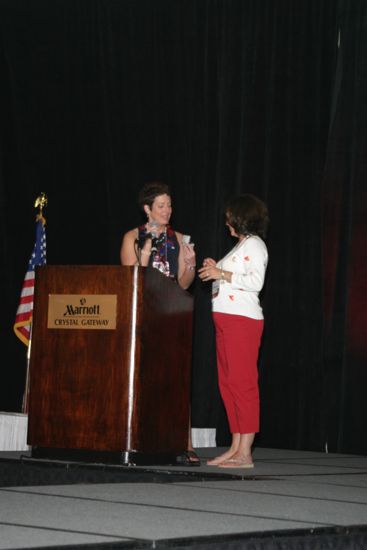 Jen Wooley Presenting Gift to Unidentified Phi Mu at Convention Photograph, July 8, 2004 (image)