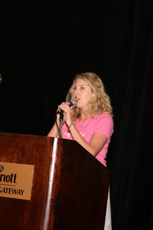 Unidentified Phi Mu Speaking at Convention Fashion Show Photograph 1, July 8, 2004 (Image)