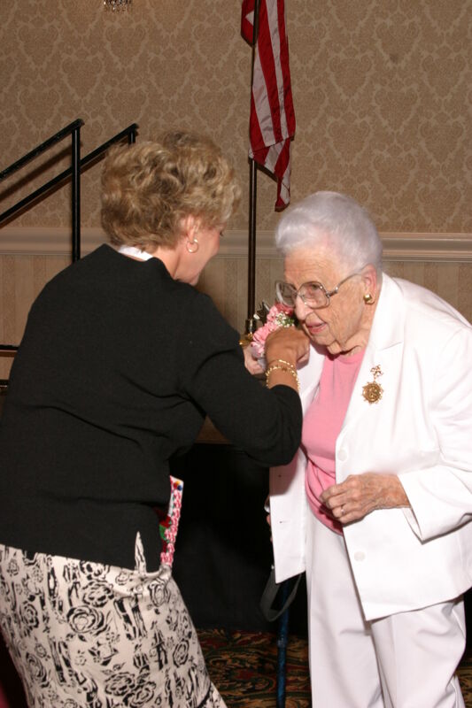 July 9 Kathie Garland Pinning Corsage on Leona Hughes at Convention Foundation Awards Presentation Photograph 1 Image