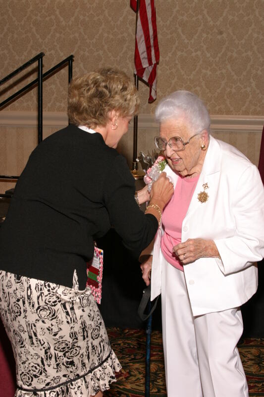 July 9 Kathie Garland Pinning Corsage on Leona Hughes at Convention Foundation Awards Presentation Photograph 2 Image