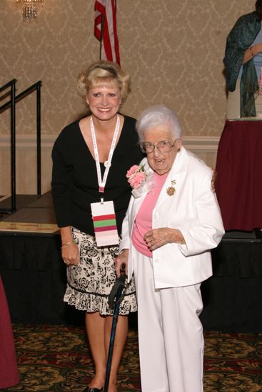 Kathie Garland Pinning Corsage on Leona Hughes at Convention Foundation Awards Presentation Photograph 4, July 9, 2004 (image)