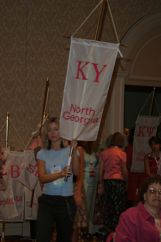 Megan Thomas With Kappa Upsilon Chapter Banner in Convention Parade of Flags Photograph, July 9, 2004 (Image)