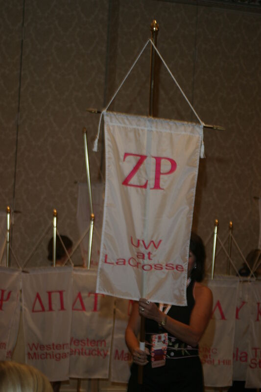 Unidentified Phi Mu With Zeta Rho Chapter Banner in Convention Parade of Flags Photograph, July 9, 2004 (Image)