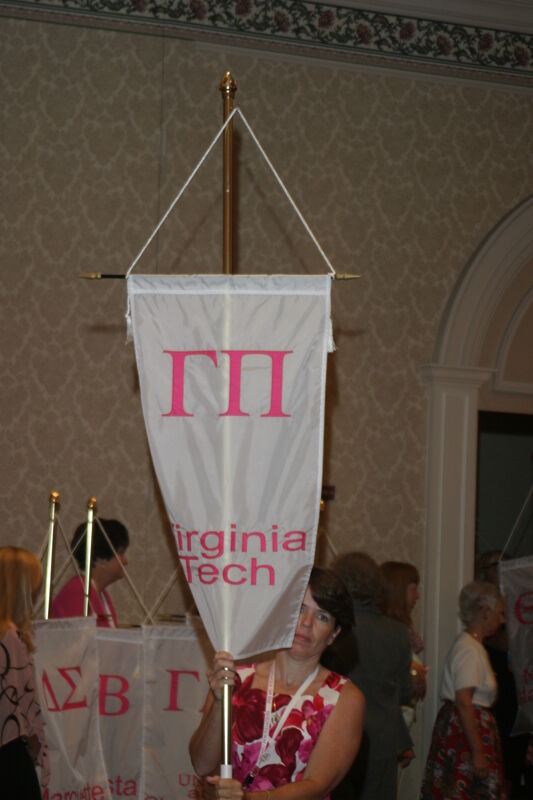 Mary Beth Straguzzi With Gamma Pi Chapter Banner in Convention Parade of Flags Photograph, July 9, 2004 (Image)