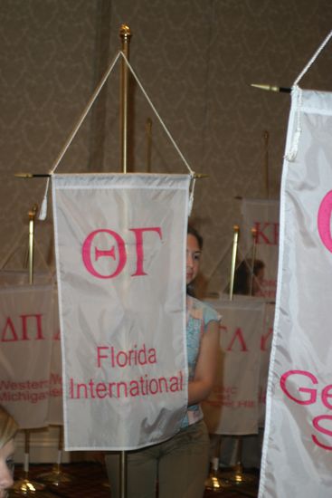 Unidentified Phi Mu With Theta Gamma Chapter Banner in Convention Parade of Flags Photograph, July 9, 2004 (image)