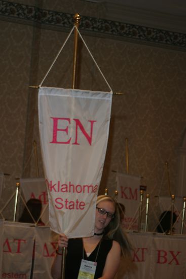 Ashley Gibson With Epsilon Nu Chapter Banner in Convention Parade of Flags Photograph, July 9, 2004 (image)