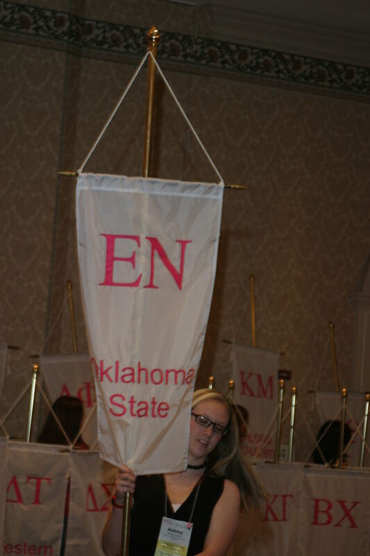 Ashley Gibson With Epsilon Nu Chapter Banner in Convention Parade of Flags Photograph, July 9, 2004 (Image)
