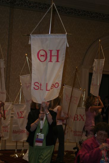 Unidentified Phi Mu With Theta Eta Chapter Banner in Convention Parade of Flags Photograph, July 9, 2004 (image)