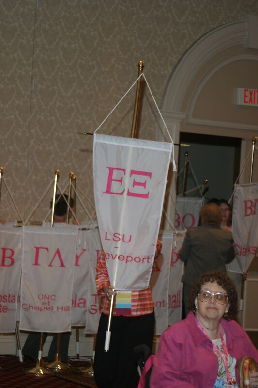 Unidentified Phi Mu With Epsilon Xi Chapter Banner in Convention Parade of Flags Photograph, July 9, 2004 (Image)