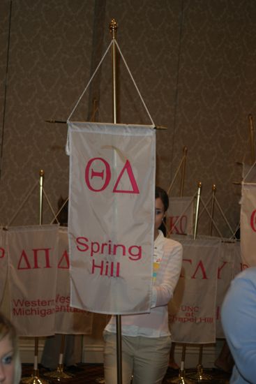 Unidentified Phi Mu With Theta Delta Chapter Banner in Convention Parade of Flags Photograph, July 9, 2004 (image)