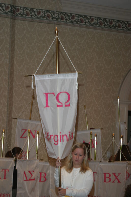 Unidentified Phi Mu With Gamma Omega Chapter Banner in Convention Parade of Flags Photograph, July 9, 2004 (Image)