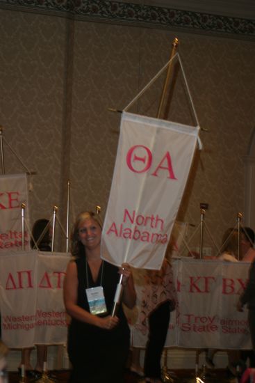 Unidentified Phi Mu With Theta Alpha Chapter Banner in Convention Parade of Flags Photograph, July 9, 2004 (image)