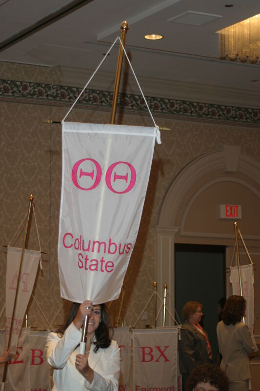 Unidentified Phi Mu With Theta Theta Chapter Banner in Convention Parade of Flags Photograph, July 9, 2004 (Image)
