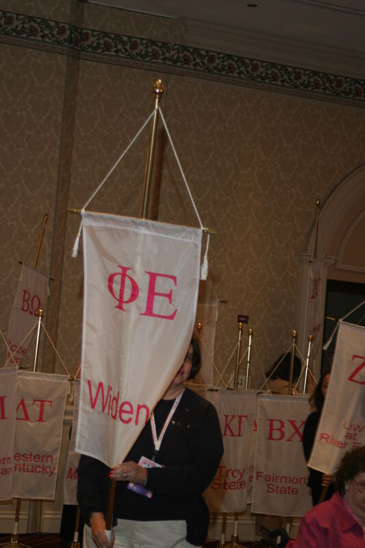 Unidentified Phi Mu With Phi Epsilon Chapter Banner in Convention Parade of Flags Photograph, July 9, 2004 (Image)