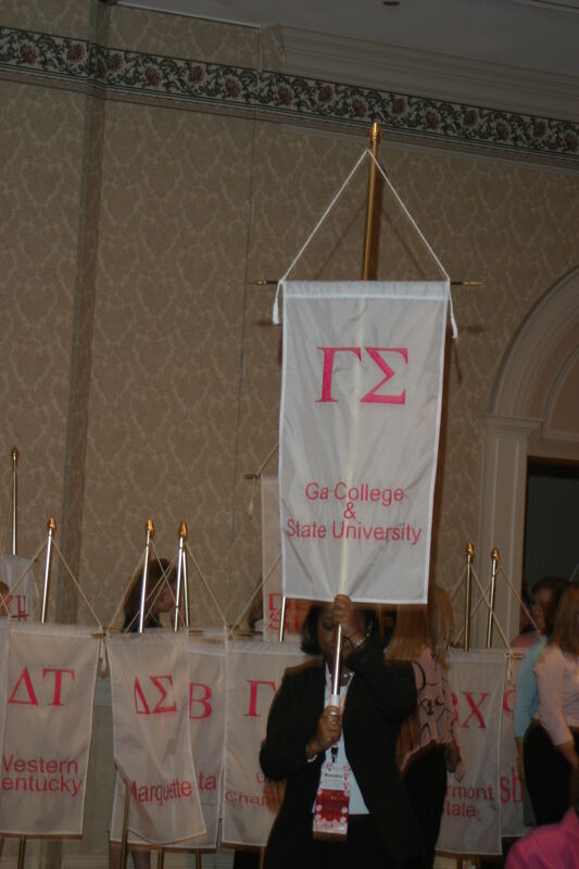 Kendra Edwards With Gamma Sigma Chapter Banner in Convention Parade of Flags Photograph, July 9, 2004 (Image)