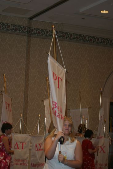 Sarah Richard With Rho Gamma Chapter Banner in Convention Parade of Flags Photograph, July 9, 2004 (image)