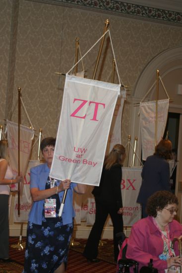 Unidentified Phi Mu With Zeta Tau Chapter Banner in Convention Parade of Flags Photograph, July 9, 2004 (image)