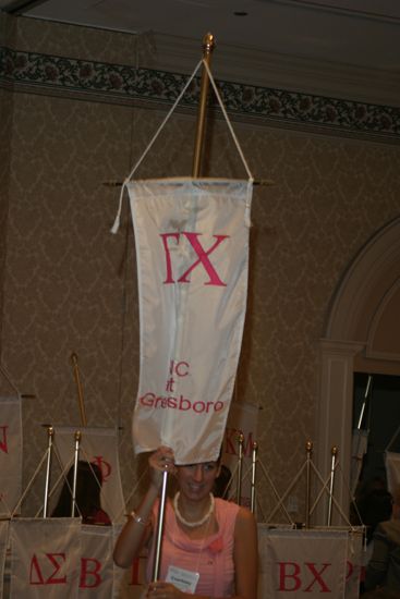 Courtney Foerster With Gamma Chi Chapter Banner in Convention Parade of Flags Photograph, July 9, 2004 (image)