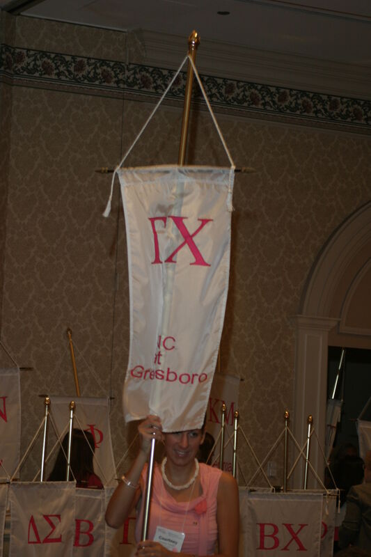 Courtney Foerster With Gamma Chi Chapter Banner in Convention Parade of Flags Photograph, July 9, 2004 (Image)