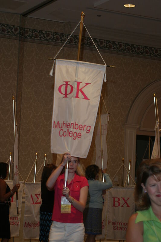 Dorie Morgan With Phi Kappa Chapter Banner in Convention Parade of Flags Photograph, July 9, 2004 (Image)