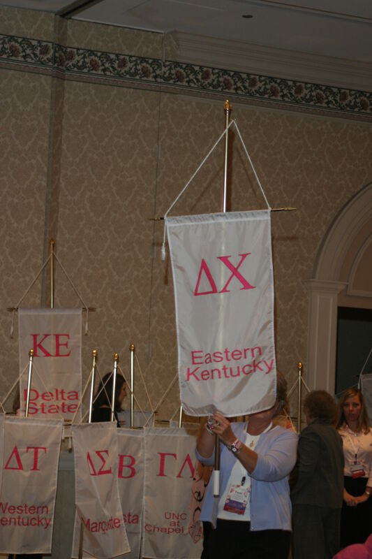 Unidentified Phi Mu With Delta Chi Chapter Banner in Convention Parade of Flags Photograph, July 9, 2004 (Image)