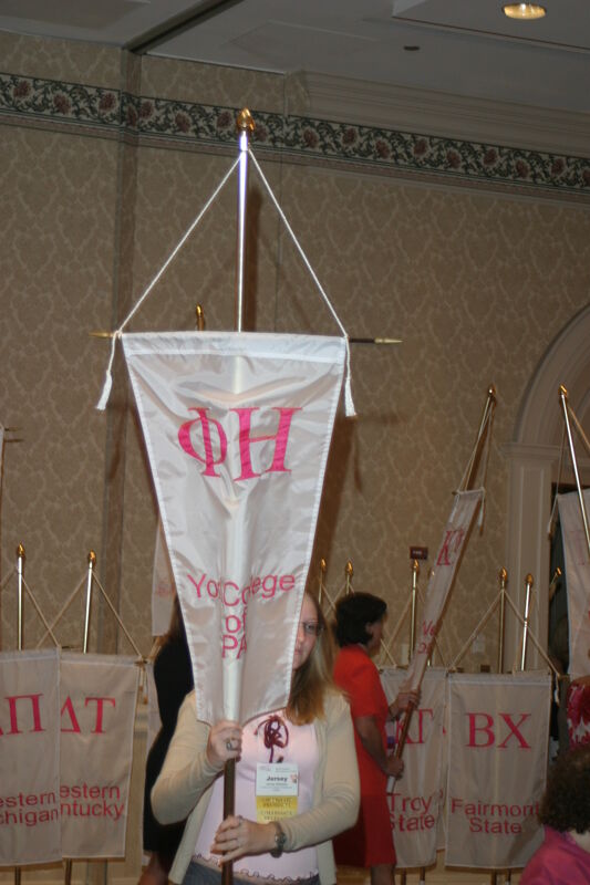 Jersey Gillespie With Phi Eta Chapter Banner in Convention Parade of Flags Photograph, July 9, 2004 (Image)