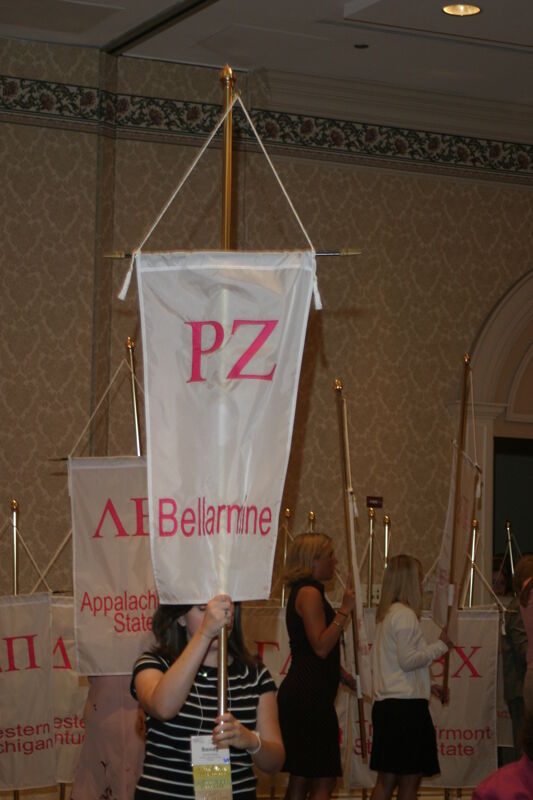 Unidentified Phi Mu With Rho Zeta Chapter Banner in Convention Parade of Flags Photograph, July 9, 2004 (Image)