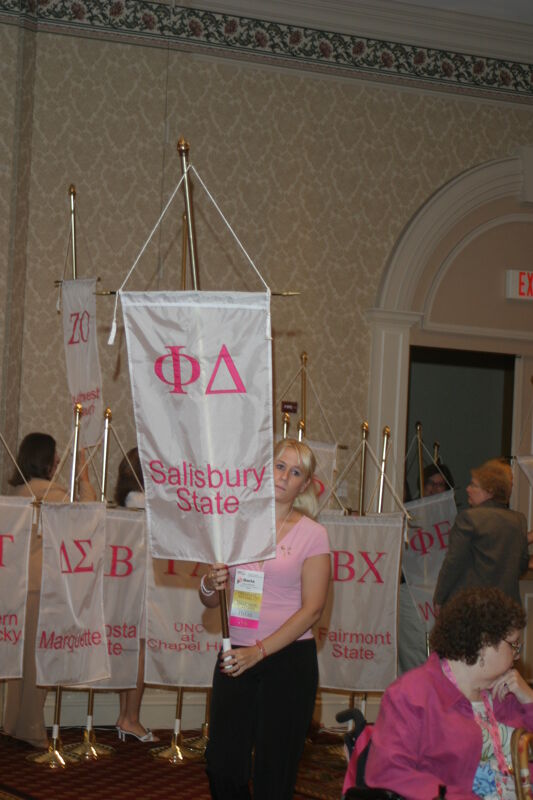 Unidentified Phi Mu With Phi Delta Chapter Banner in Convention Parade of Flags Photograph, July 9, 2004 (Image)