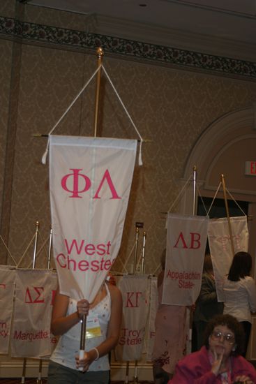 Unidentified Phi Mu With Phi Lambda Chapter Banner in Convention Parade of Flags Photograph, July 9, 2004 (image)