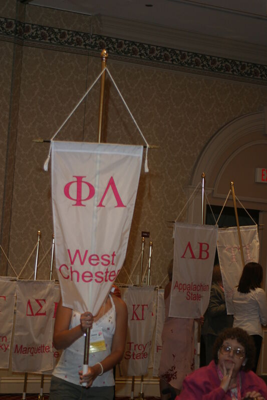 Unidentified Phi Mu With Phi Lambda Chapter Banner in Convention Parade of Flags Photograph, July 9, 2004 (Image)