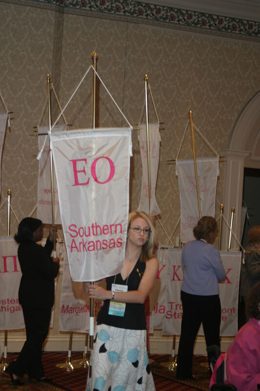 Unidentified Phi Mu With Epsilon Omicron Chapter Banner in Convention Parade of Flags Photograph, July 9, 2004 (Image)