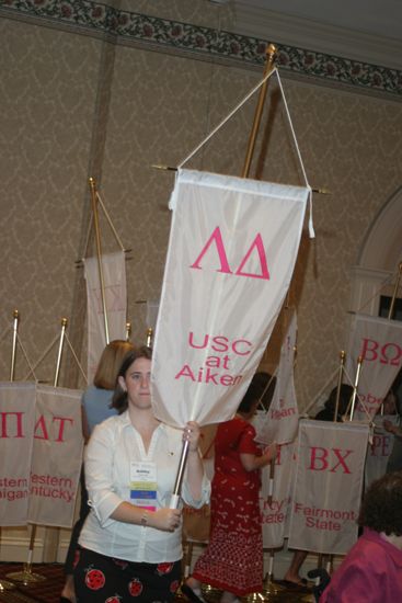 Ashley Ball With Lambda Delta Chapter Banner in Convention Parade of Flags Photograph, July 9, 2004 (image)