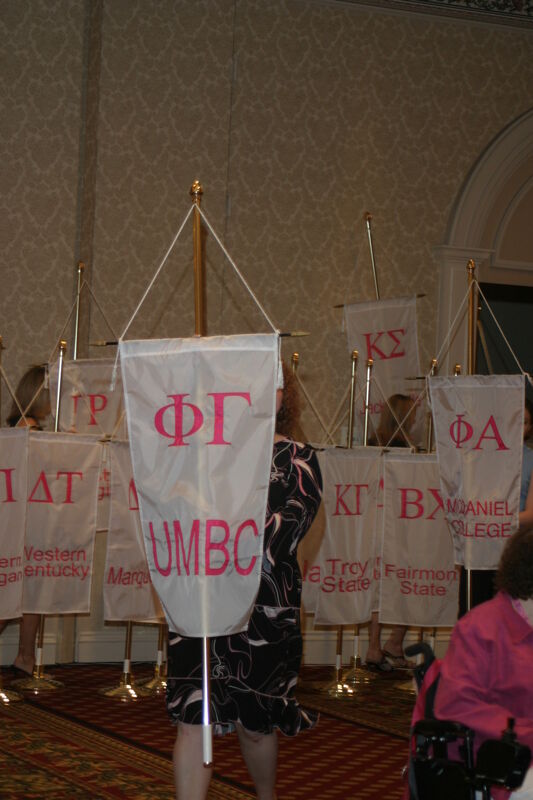 Unidentified Phi Mu With Phi Gamma Chapter Banner in Convention Parade of Flags Photograph, July 9, 2004 (Image)