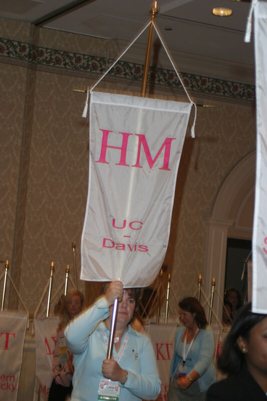 Katie Eastham With Eta Mu Chapter Banner in Convention Parade of Flags Photograph, July 9, 2004 (Image)