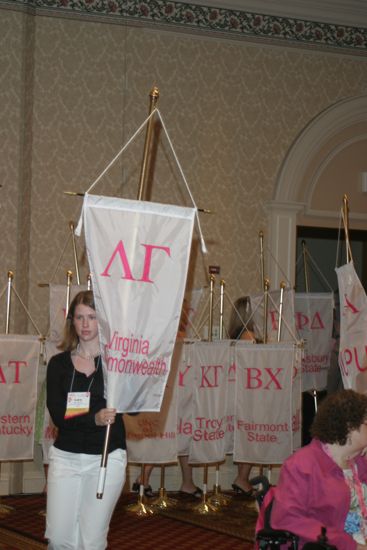 Lara Perlman With Lambda Gamma Chapter Banner in Convention Parade of Flags Photograph, July 9, 2004 (image)