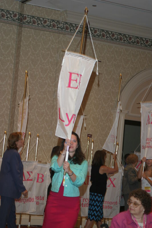 Unidentified Phi Mu With Epsilon Rho Chapter Banner in Convention Parade of Flags Photograph, July 9, 2004 (Image)