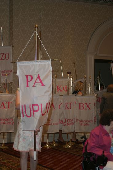 Unidentified Phi Mu With Rho Alpha Chapter Banner in Convention Parade of Flags Photograph, July 9, 2004 (image)